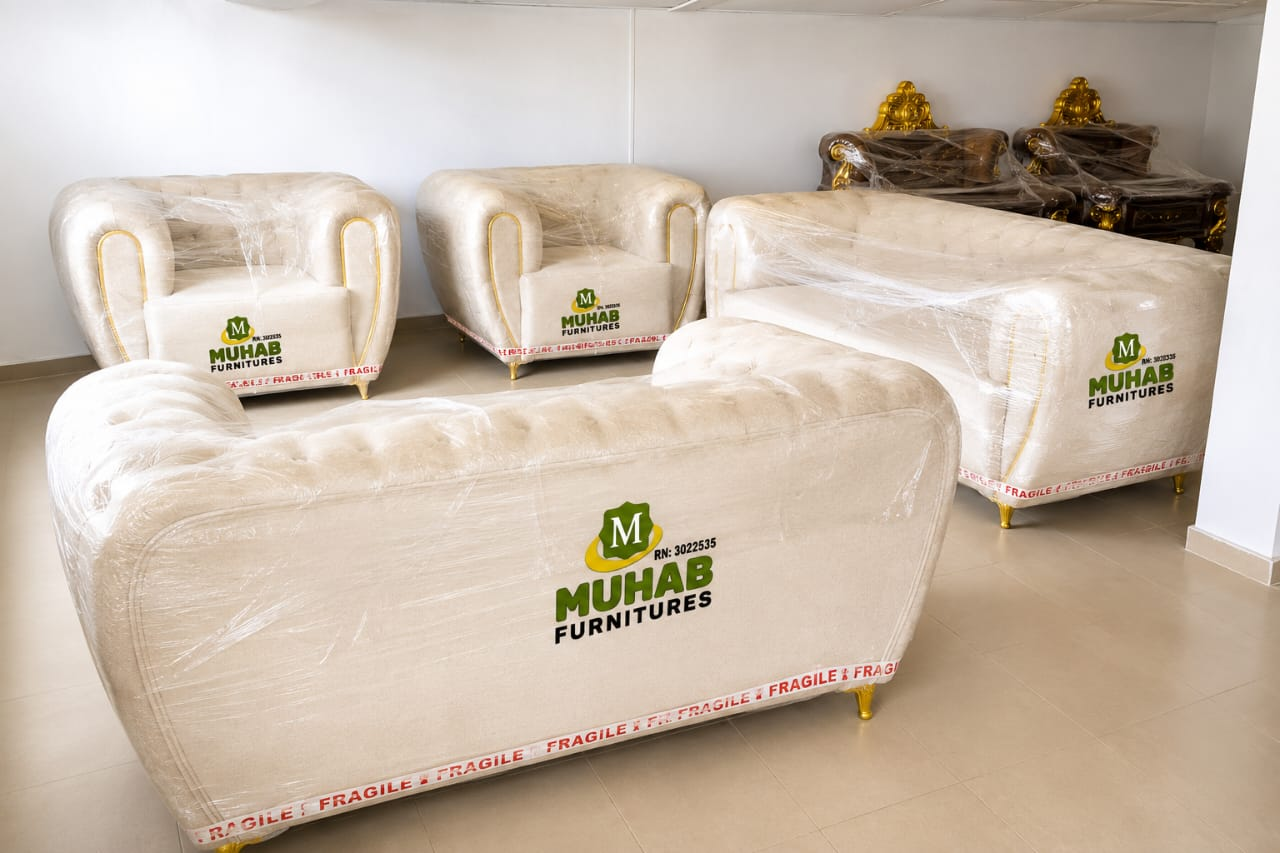 Light-coloured sofa and matching armchairs photographed in an interior